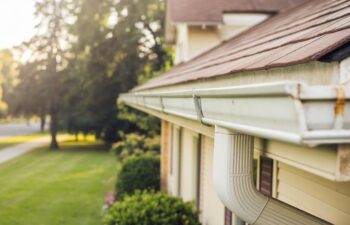 A picture of a home with white gutters